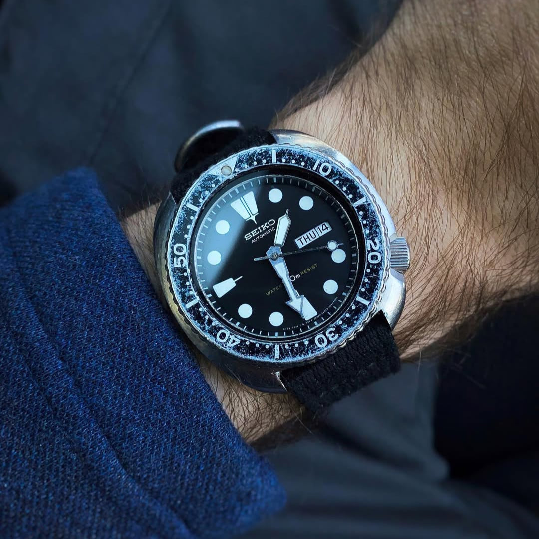 Collector's favorite Seiko 6309 Turtle with faded bezel worn on RSM Vintage Military black strap with matching distressed hardware.