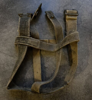 Inspired by vintage cotton military webbing, this olive strap features worn, rugged webbing and distressed hardware for a bold look.