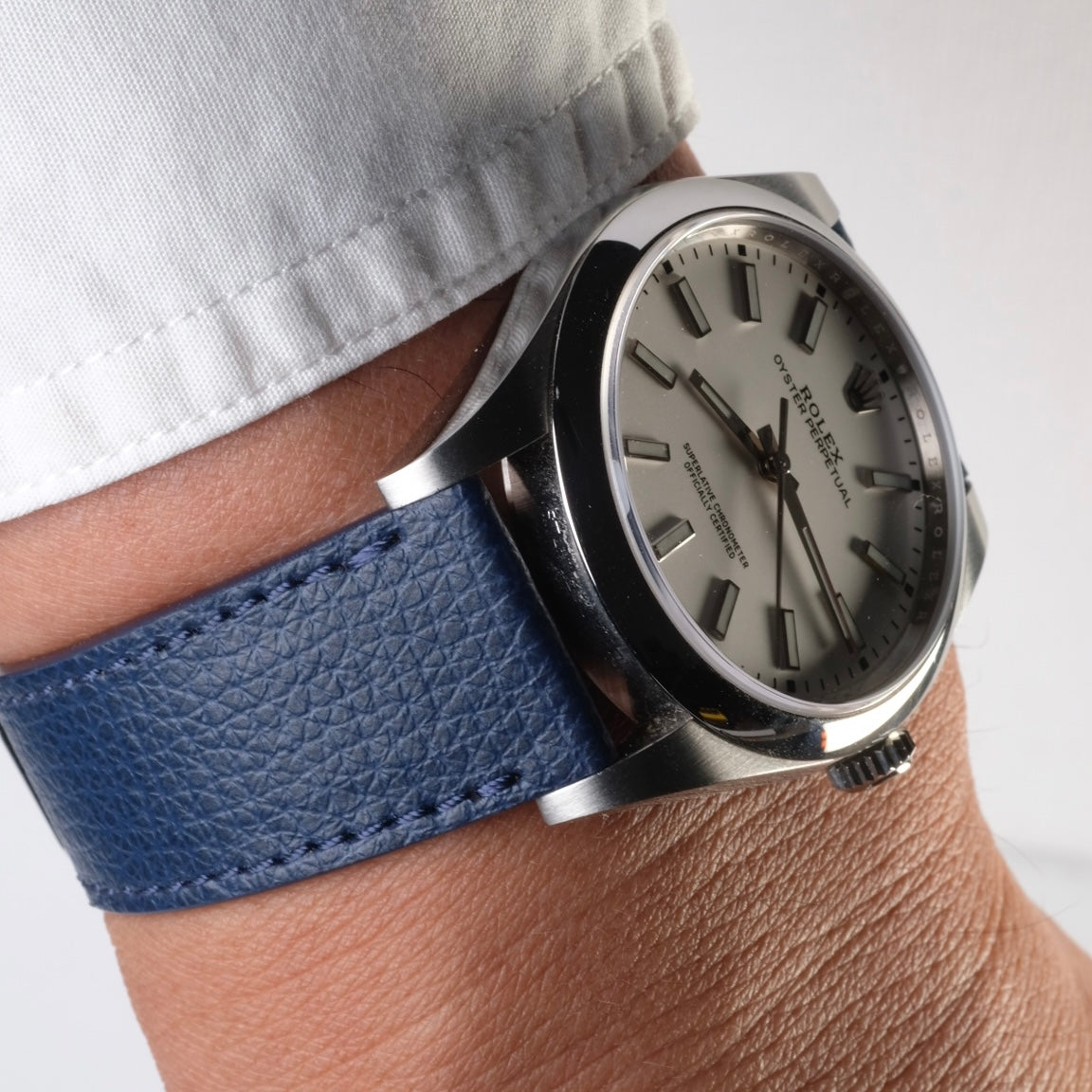 A man wearing on his wrist a Rolex Oyster Perpetual paired with an Italian Epsom Leather Watch Strap in Navy Blue by RSM Watch Strap