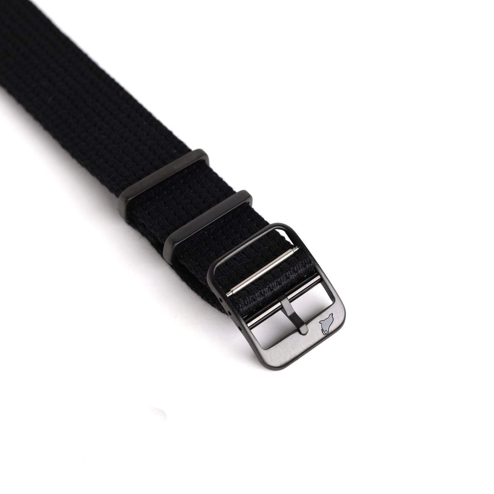 Close-up of RSM Watch Straps VTG Mil in Black: a black woven strap with a matte black buckle, stylized logo, and two loops.