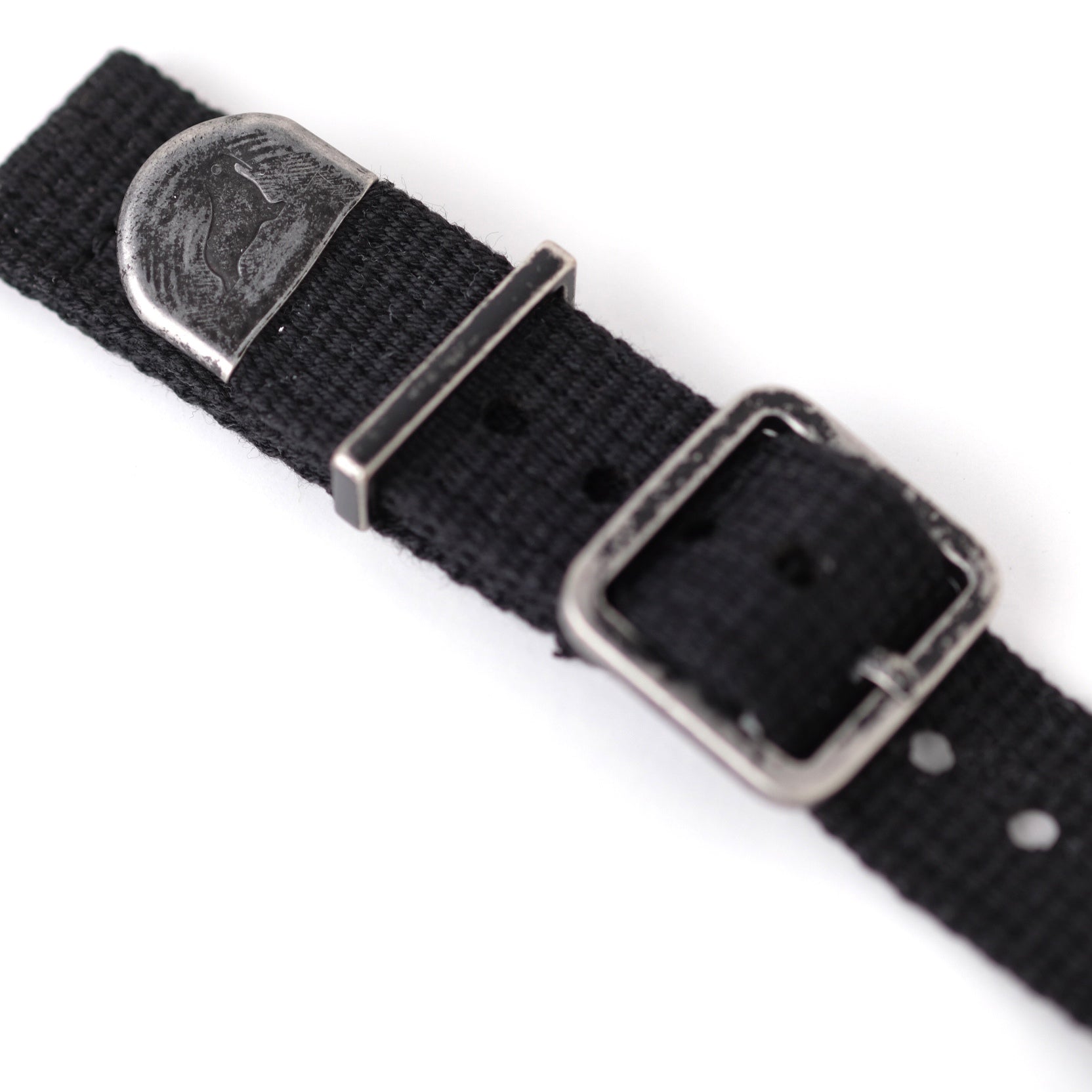 Close-up of RSM Vintage Military 2-Piece (Black) strap with polycotton band, silver buckle, walrus-engraved plate, and distressed hardware.