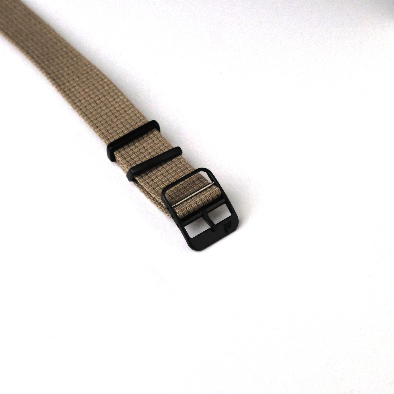 Close-up of the VTG Mil in Green by RSM Watch Strap, featuring a beige woven design, stainless steel buckle, and two black loops on a white background.