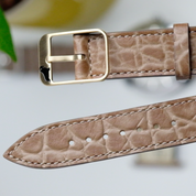 Close-up of the RSM Watch Strap Alligator Circular Grain Calf Leather Watch Strap in Taupe, featuring embossed texture, a gold buckle, and precise stitching—a refined showcase of Japanese craftsmanship.