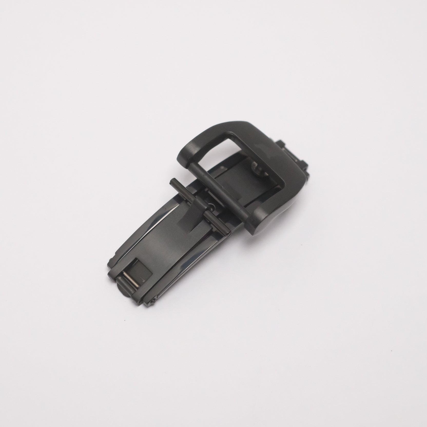 Black matte deployant clasp in folded position, featuring a butterfly double fold with spring-loaded blades for secure open/close function.