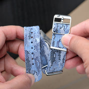 A person holds the RSM Watch Strap Ocean Camo Adjustable Single Pass Watch Strap, featuring jacquard-woven polyester, stainless steel hardware, a silver buckle, textured detail, and adjustment holes.