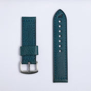 The Leather Watch Strap in Blue by RSM Watch Strap features two teal leather pieces with visible stitching—one with a silver buckle, the other with adjustment holes—displayed on a plain white background.