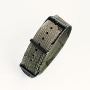 The RSM Watch Strap Forest Camo Adjustable Single Pass features a green woven nylon strap with subtle camouflage, a matte black buckle, and multiple adjustment holes, displayed on a white background.