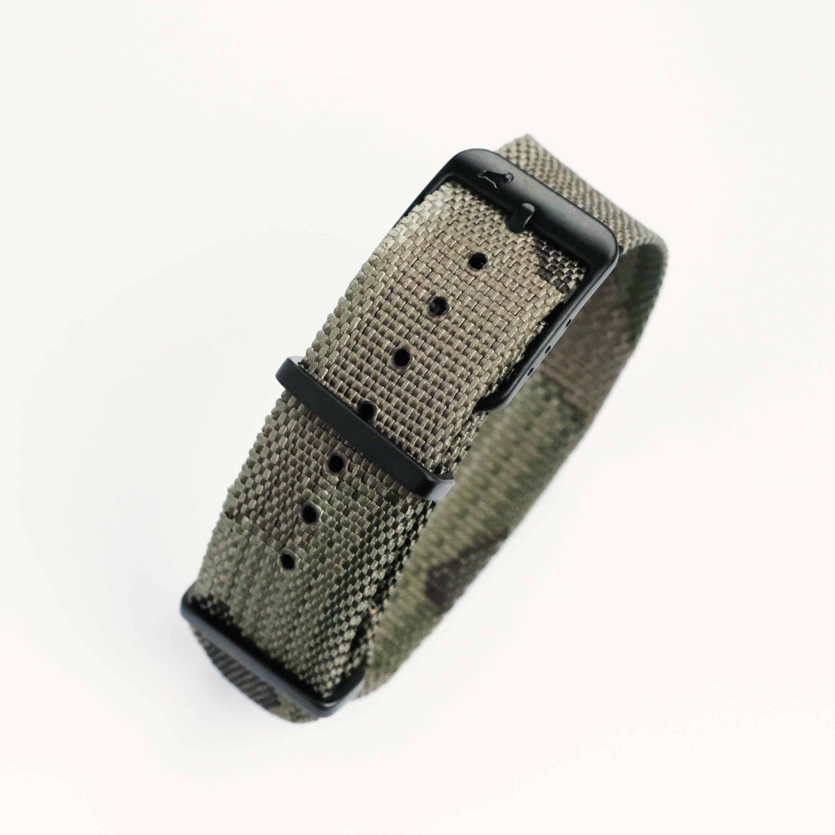 The RSM Watch Strap Forest Camo Adjustable Single Pass features a green woven nylon strap with subtle camouflage, a matte black buckle, and multiple adjustment holes, displayed on a white background.