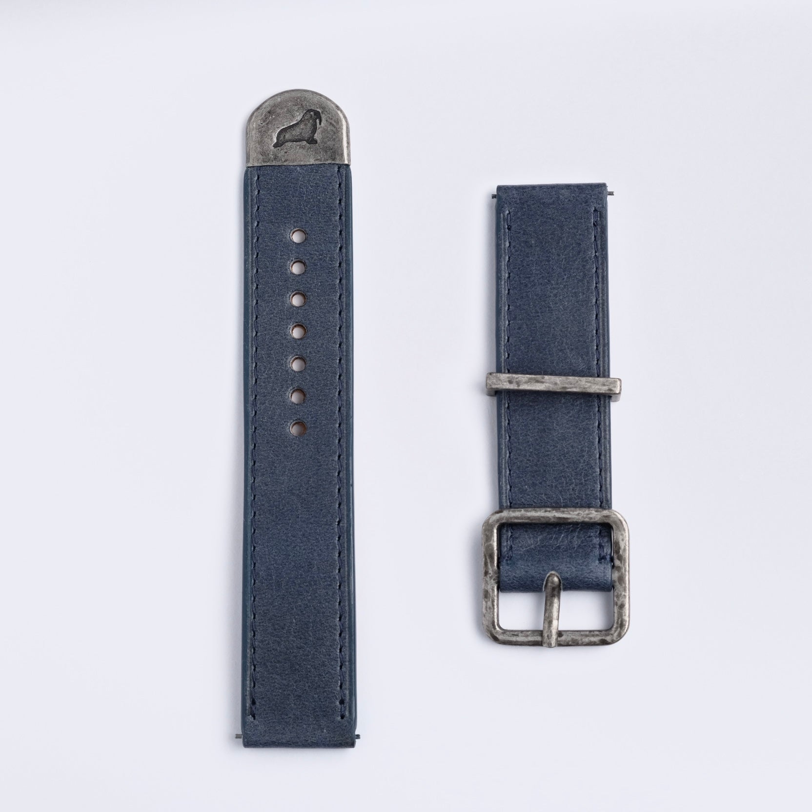 The RSM Watch Strap Distressed Leather Watch Strap in Blue features two pieces with silver metal accents—a buckle on one and an engraved animal on the metal tip—displayed against a plain white background.