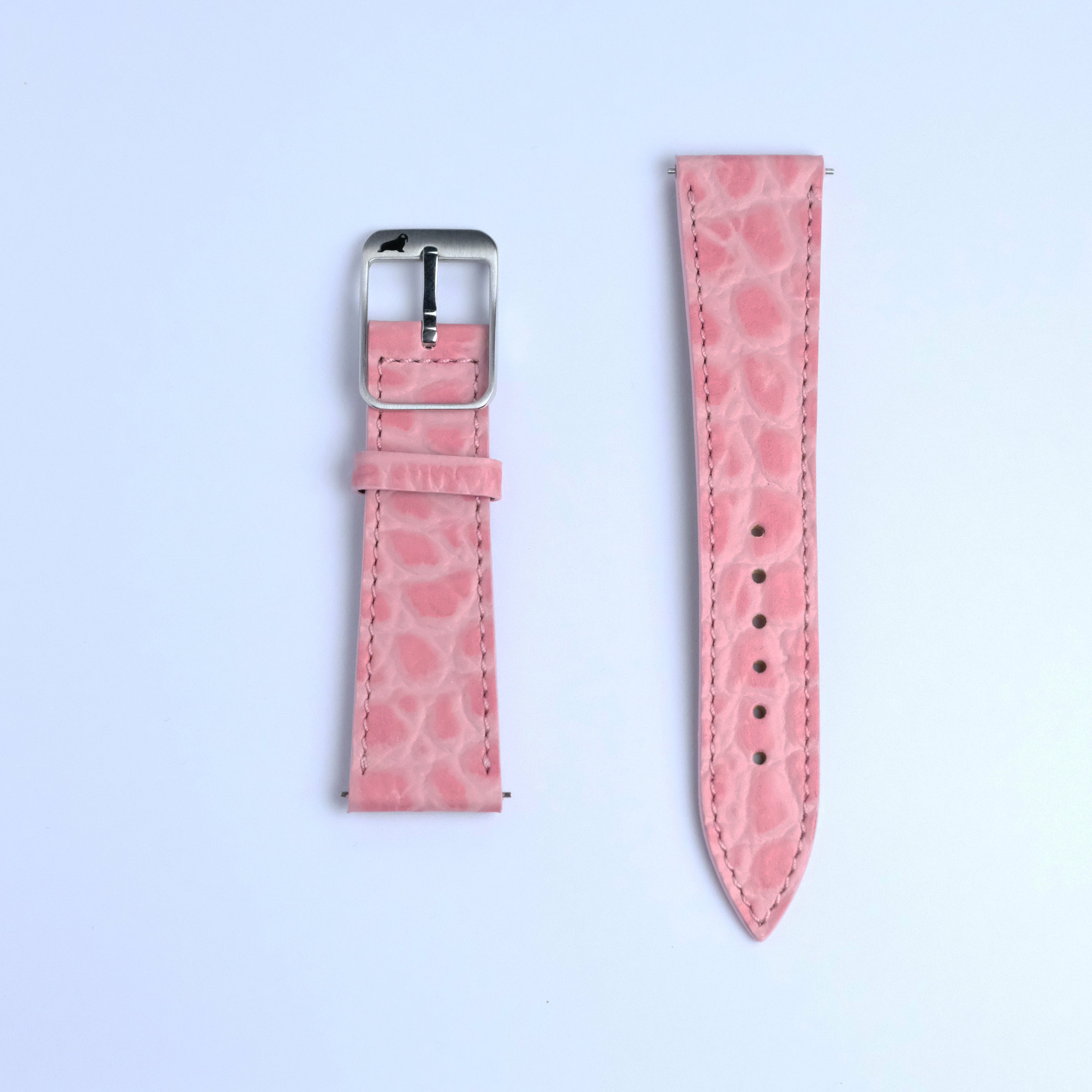 Two pieces of the RSM Watch Strap’s Alligator Circular Grain Calf Leather Watch Strap in Pink are displayed on a white background; the left has a silver buckle, and the right features several adjustment holes.