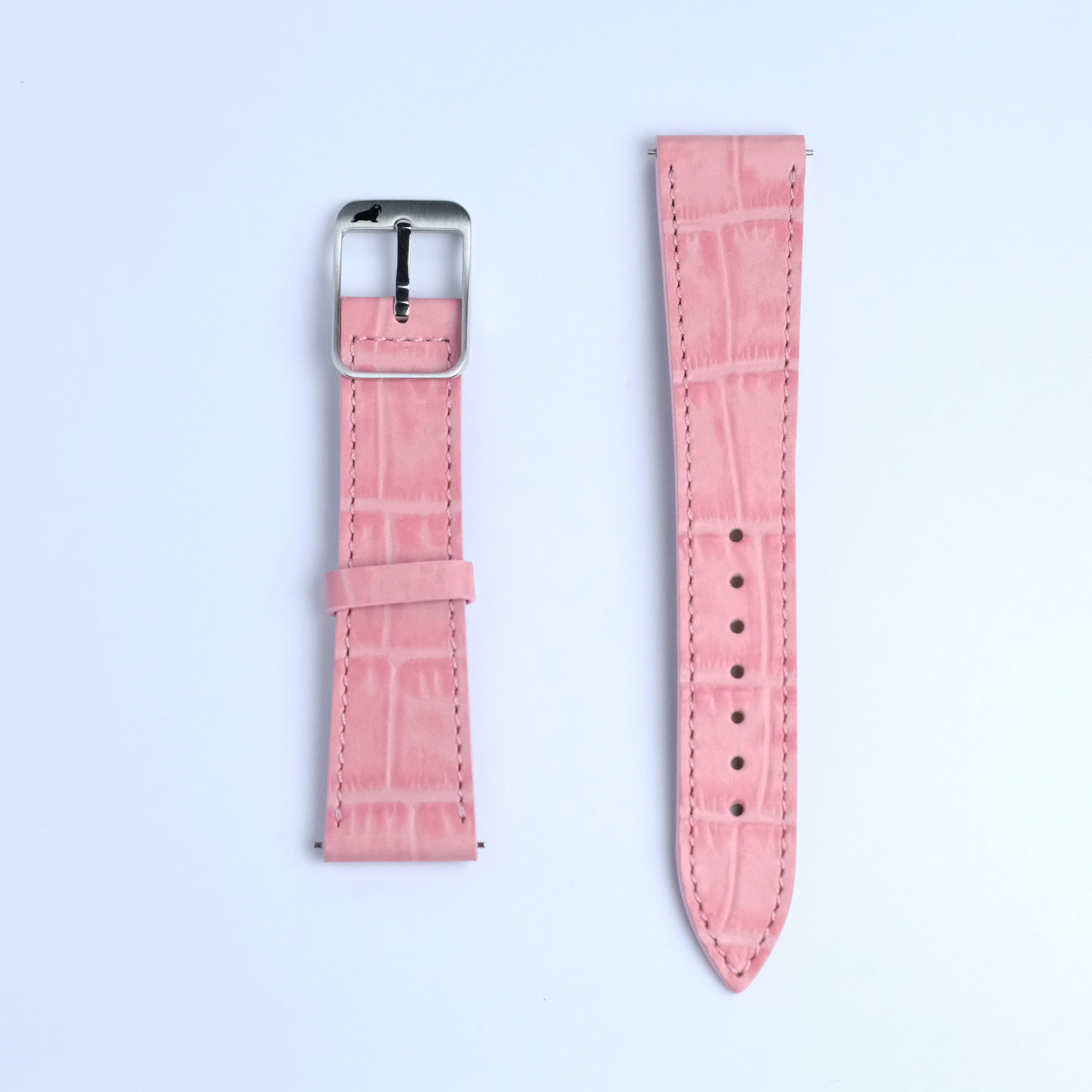 Two pieces of the RSM Watch Strap’s Alligator Grain Calf Leather Watch Strap in Pink are laid flat on a white background: the left has a silver buckle, and the right features multiple holes for adjustment.