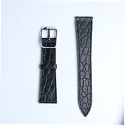 Two pieces of the RSM Watch Strap's Alligator Circular Grain Calf Leather Watch Strap in Black are shown on a white background: one with a silver buckle, the other with adjustment holes.