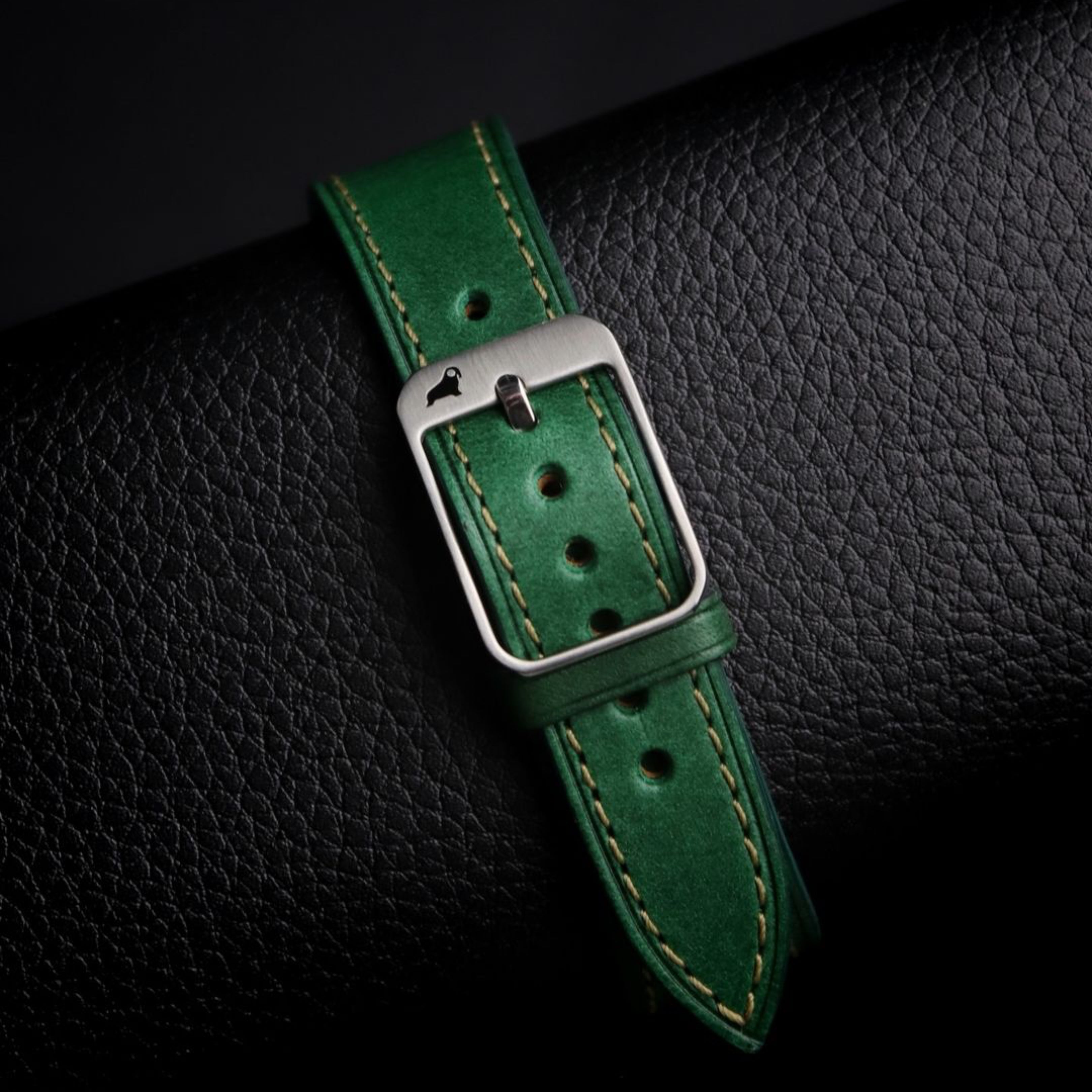 Green Buttero leather strap with RSM 316L stainless steel buckle, clean punched holes, and a beautiful stretched bent leather section.
