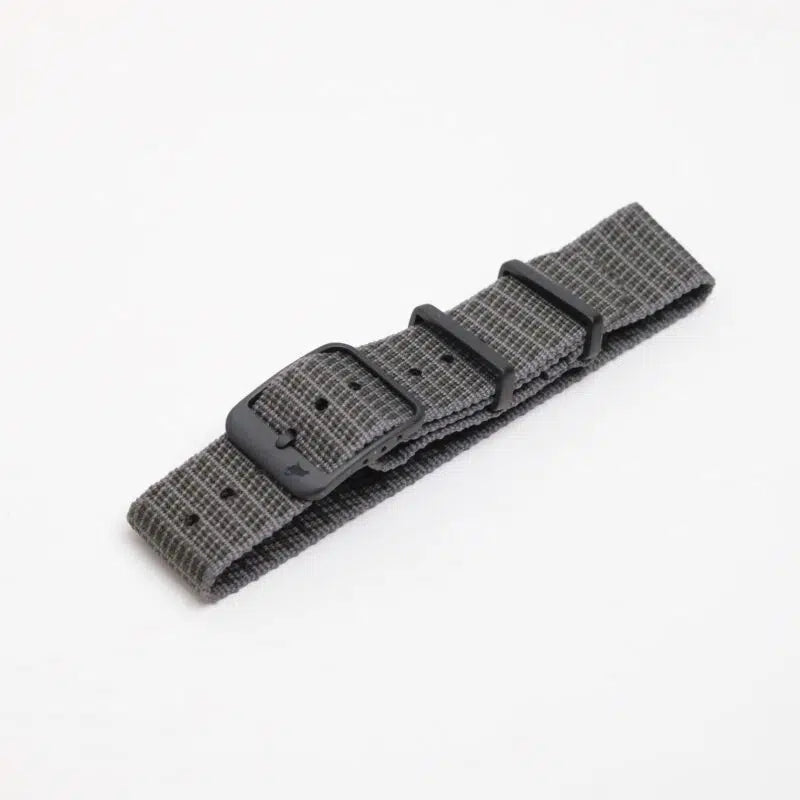 The RSM Watch Strap X-Hatch Single Pass Watch Strap in Green features a subtle small checkered pattern, black buckle, and two black loops, displayed on a plain white background.