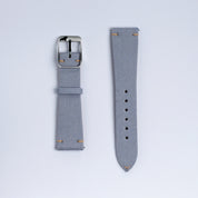 Two pieces of the RSM Watch Strap Fine Canvas Watch Strap in Metallic Blue, with a silver buckle and small tan edge stitching, are laid out on a plain white background.