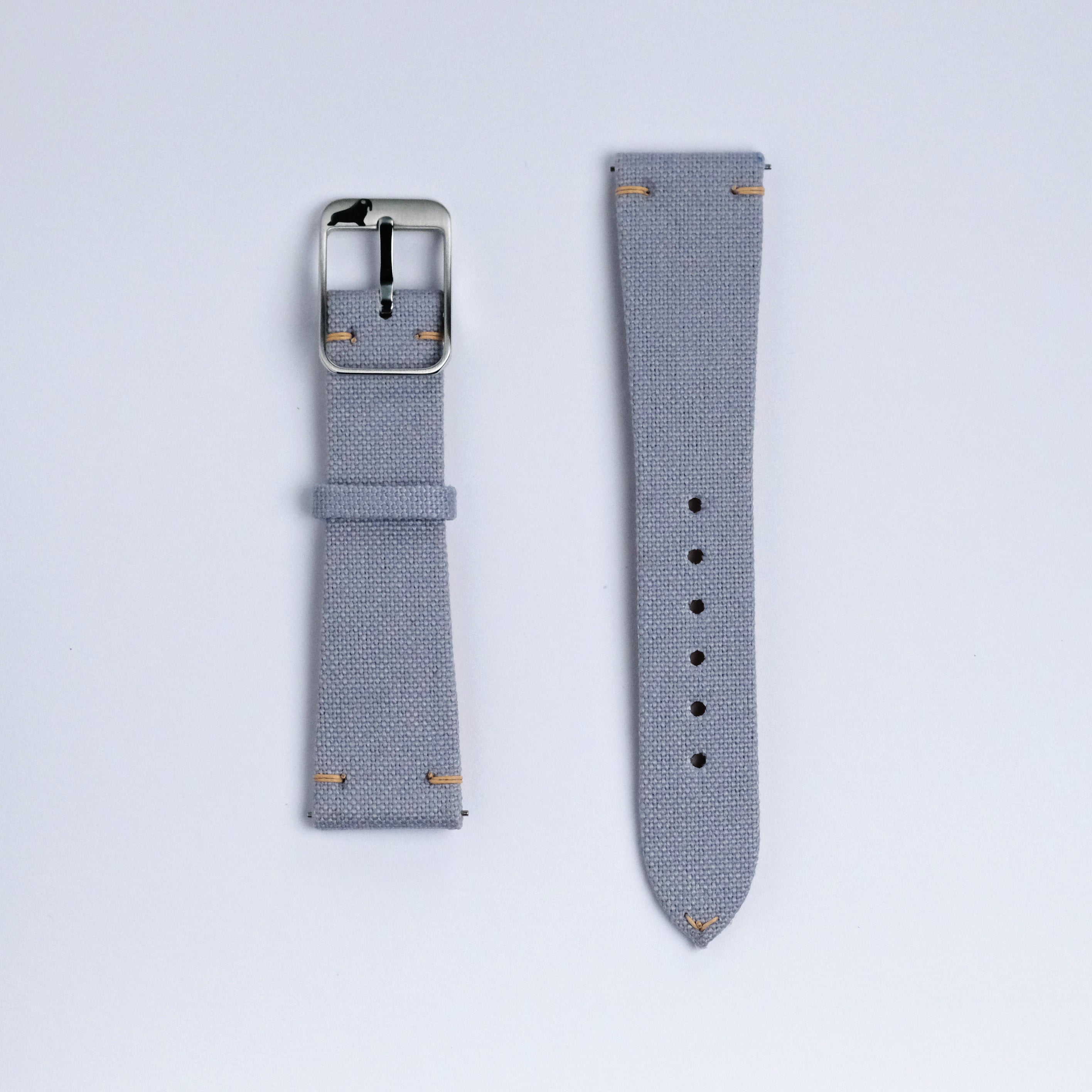 Two pieces of the RSM Watch Strap Fine Canvas Watch Strap in Metallic Blue, with a silver buckle and small tan edge stitching, are laid out on a plain white background.