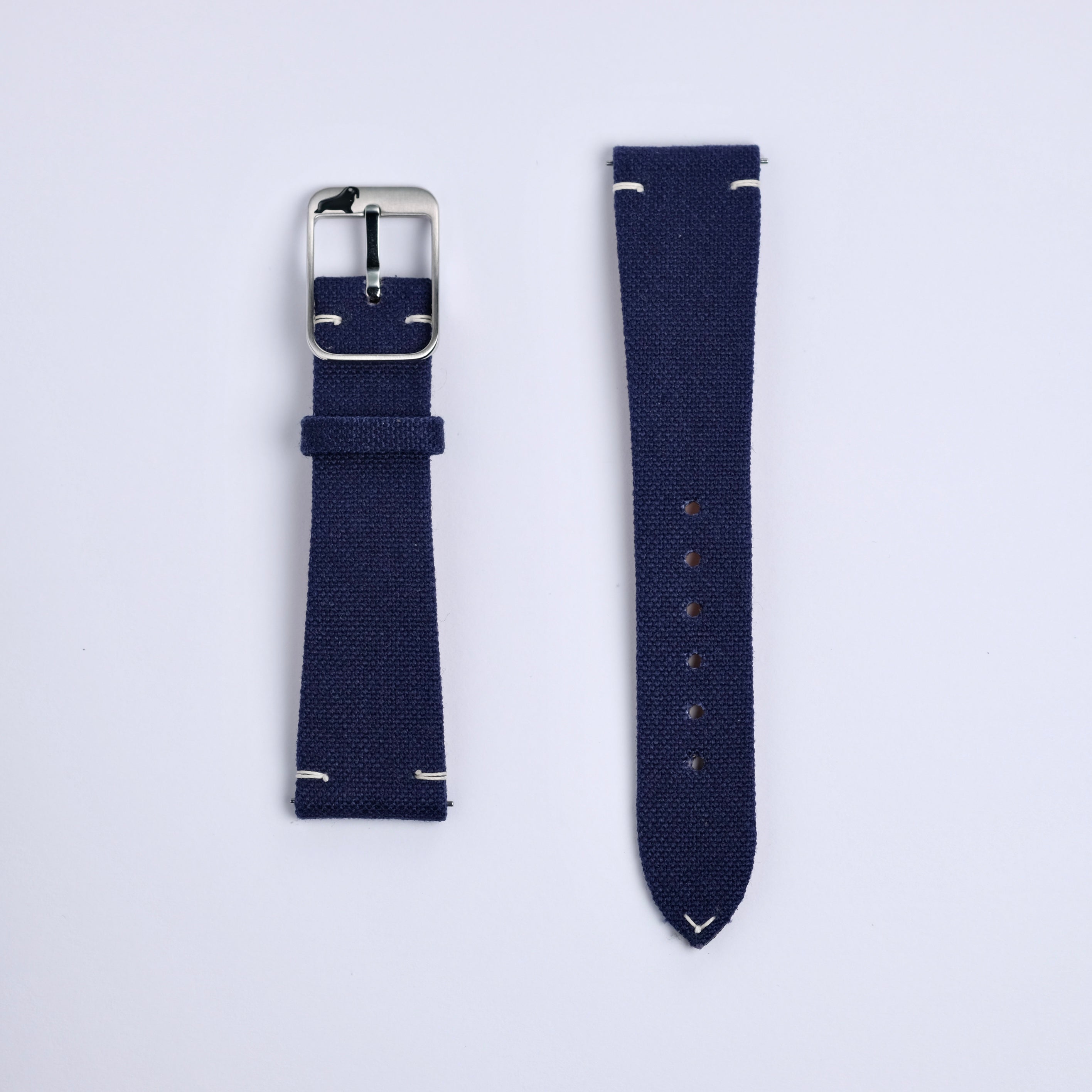 Two Fine Canvas Watch Straps in Navy Blue by RSM Watch Strap are shown side by side on a light background. One features a silver buckle, the other adjustment holes; both have white stitching at the ends.