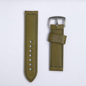 The Leather Watch Strap in Green by RSM Watch Strap is shown in two pieces—one with holes, the other with a silver buckle—crafted from green leather with stitching and displayed against a white background.
