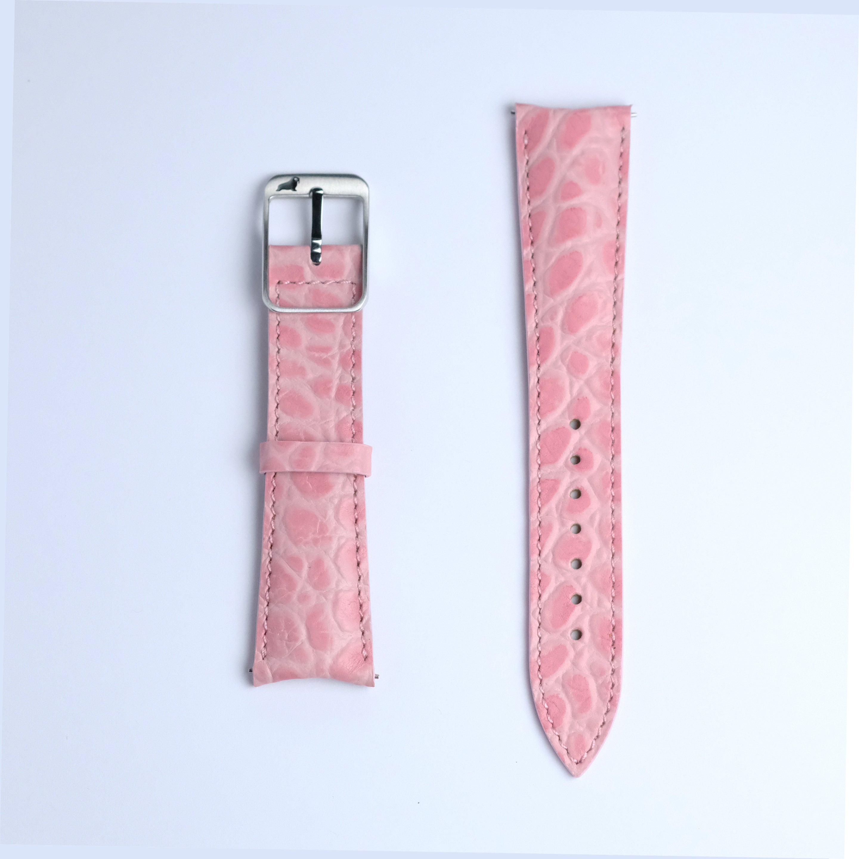 Two pieces of the RSM Watch Strap Curved Lugs Alligator Circular Grain Watch Strap in Pink, featuring Japanese craftsmanship, are shown side by side—one with a silver buckle and one with adjustment holes—on a white background.
