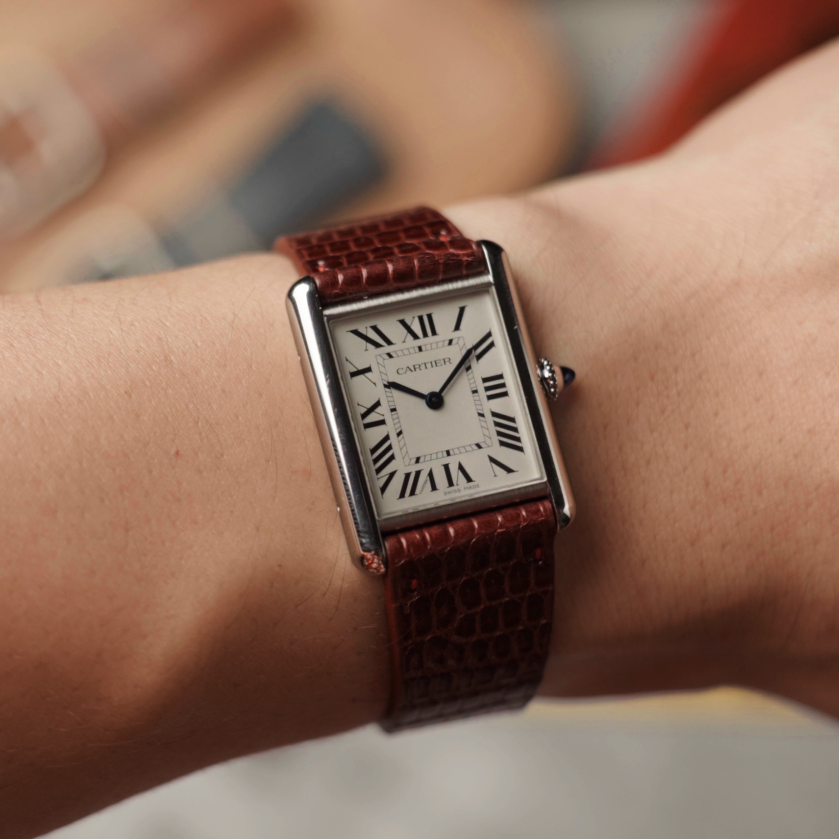 Cartier Tank with RSM's red lizard leather watch strap on a man's wrist