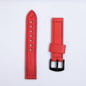 The Leather Watch Strap in Red by RSM Watch Strap features two red leather pieces with black stitching—one with holes, the other with a black buckle—displayed side by side on a white background.