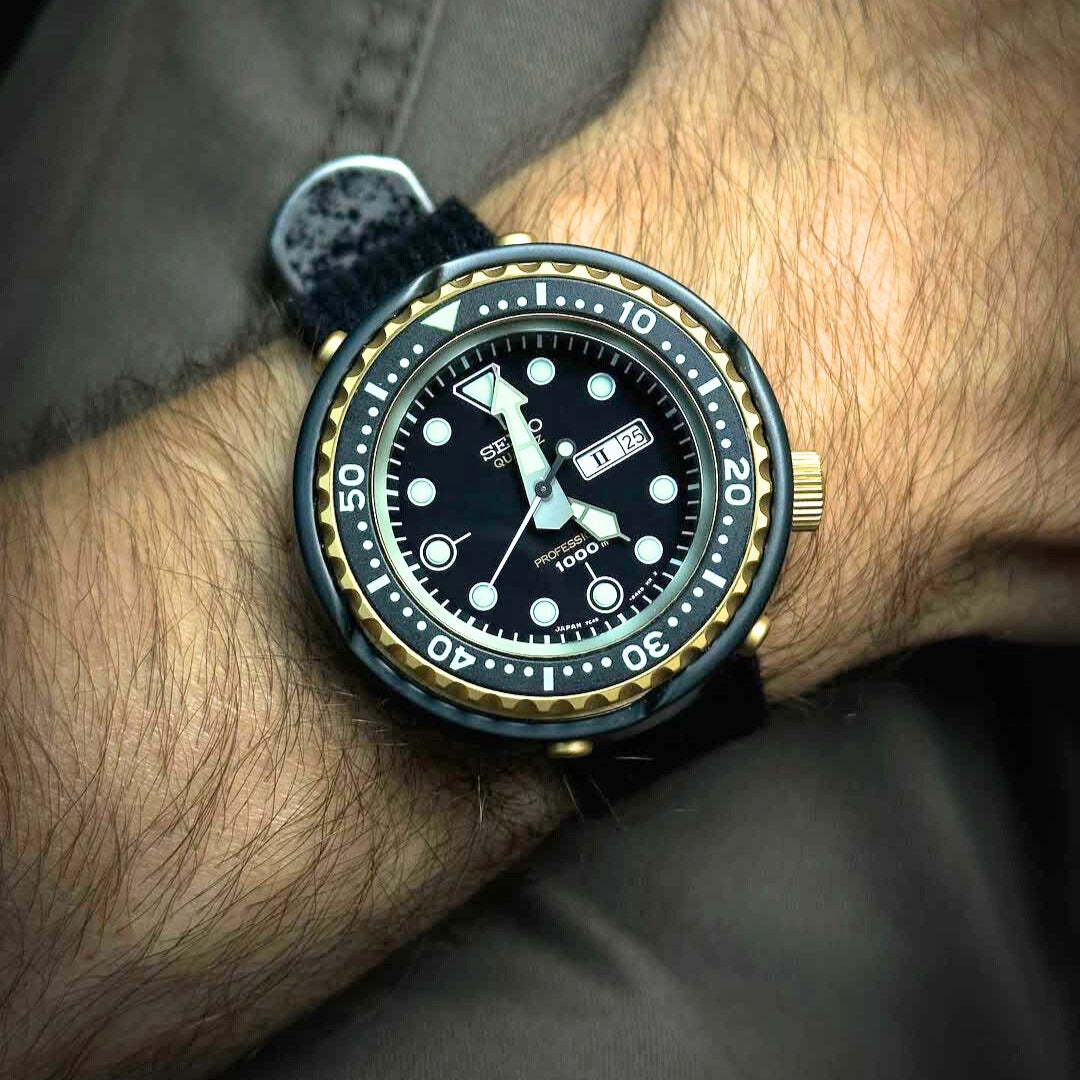 The Seiko Tuna Can gold medal diver, worn with RSM's vintage military black poly cotton strap and distressed hardware, over casual pants.