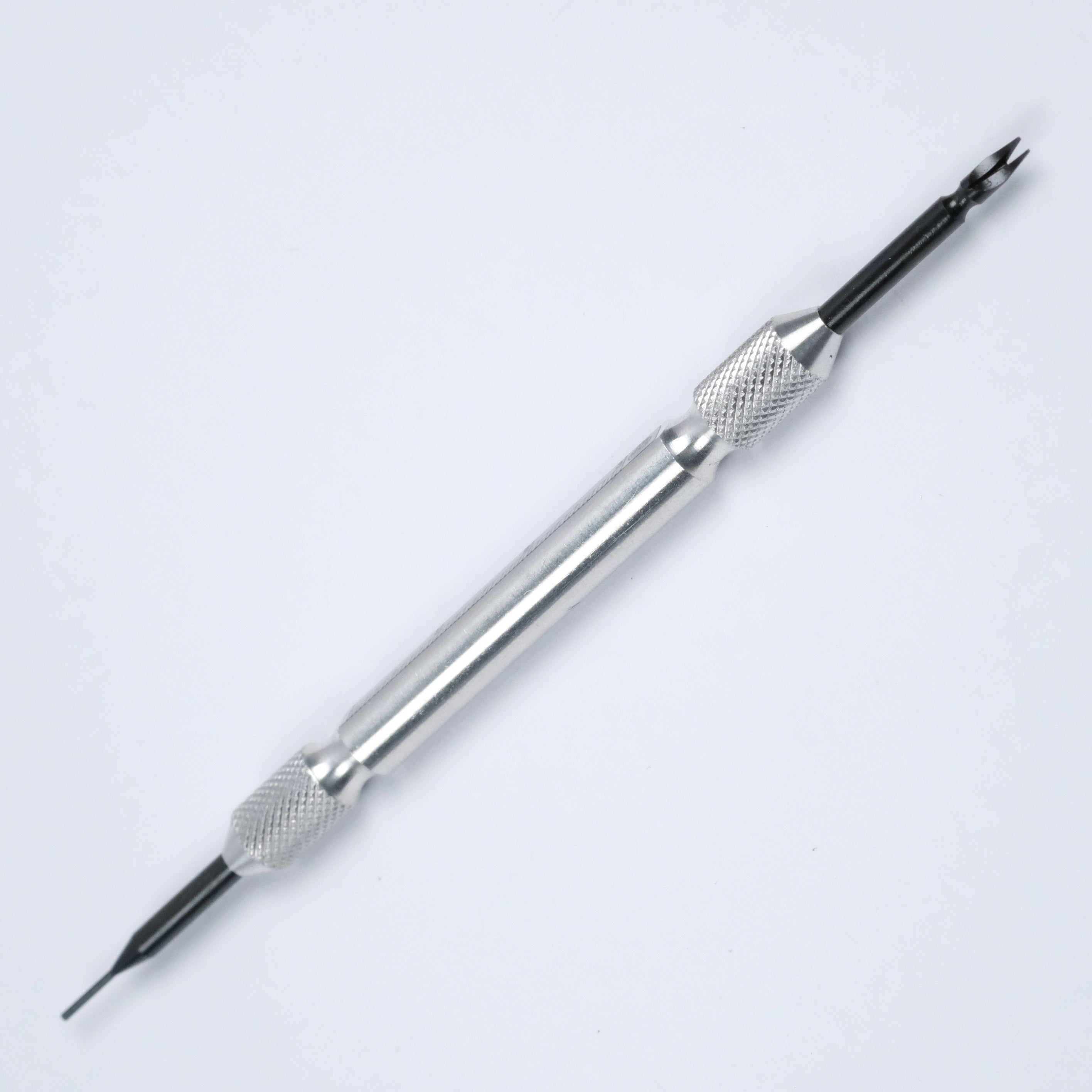 The RSM Watch Strap Spring Bar Tool is a metal accessory with a textured grip, featuring a sharp pointed tip on one end and a forked prong on the other for easy watch strap changes. Made in Japan, it is showcased against a white background.