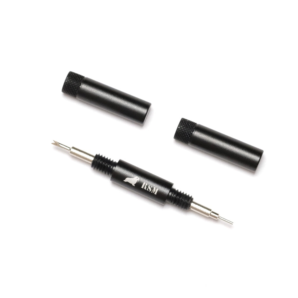 The RSM Watch Strap Basic Spring Bar Tool is black and silver with a forked and pointed end, two removable black caps, a bird logo, and the letters BSM on its body.