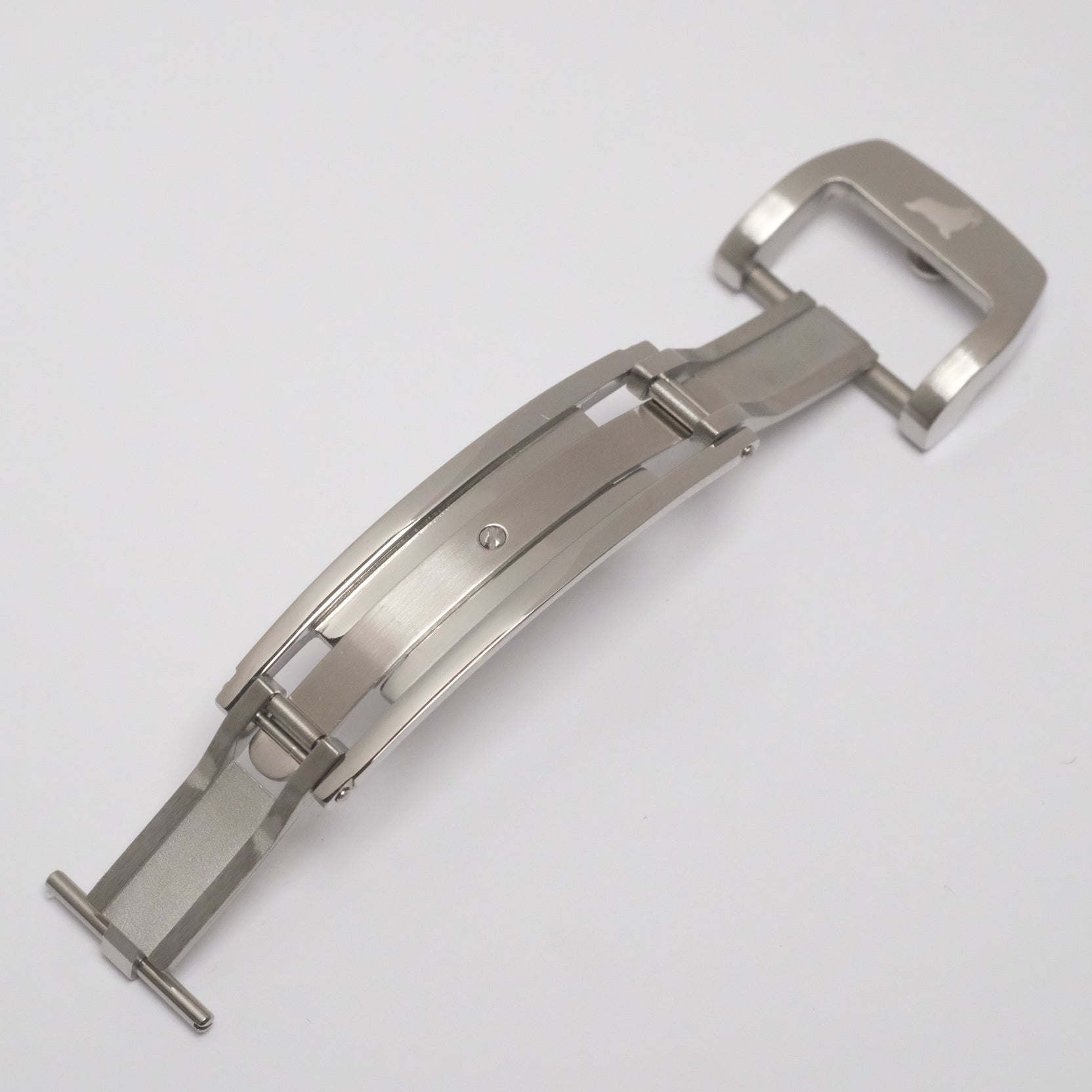Stainless steel deployant clasp unfolded, showcasing the mechanical strips that secure it in either the 'closed' or 'open' position.