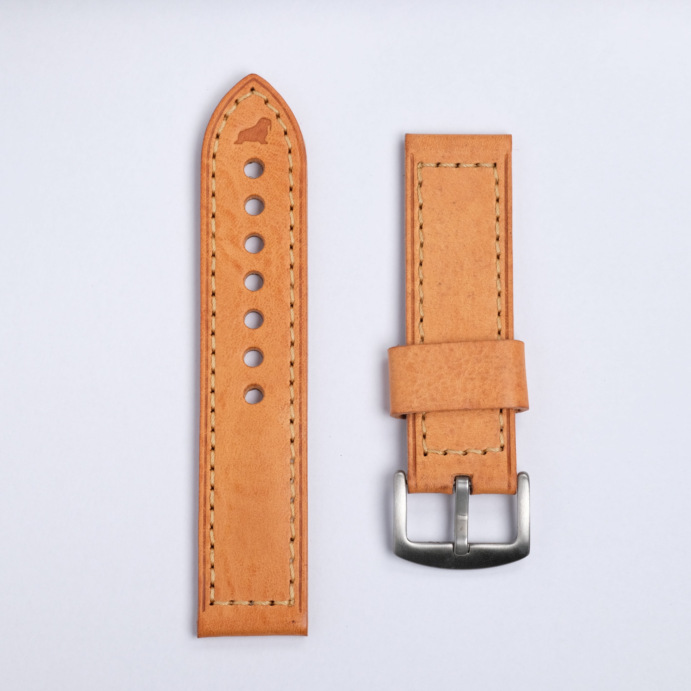 Two RSM Watch Strap "The Leather Watch Strap in Caramel" are shown side by side with beige stitching—one with holes, the other with a silver buckle. A luxurious neutral upgrade and an ideal complimentary gift for any watch lover.
