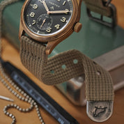 Vertex Bronze watch fitted on RSM vintage military cotton strap with distressed hardware. End tips shows RSM's walrus logo. 