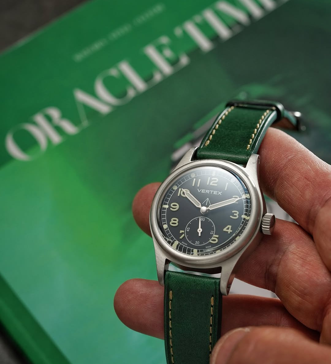 A hand holding a watch fitted with the RSM Watch Strap Buttero Leather Watch Strap in Green.