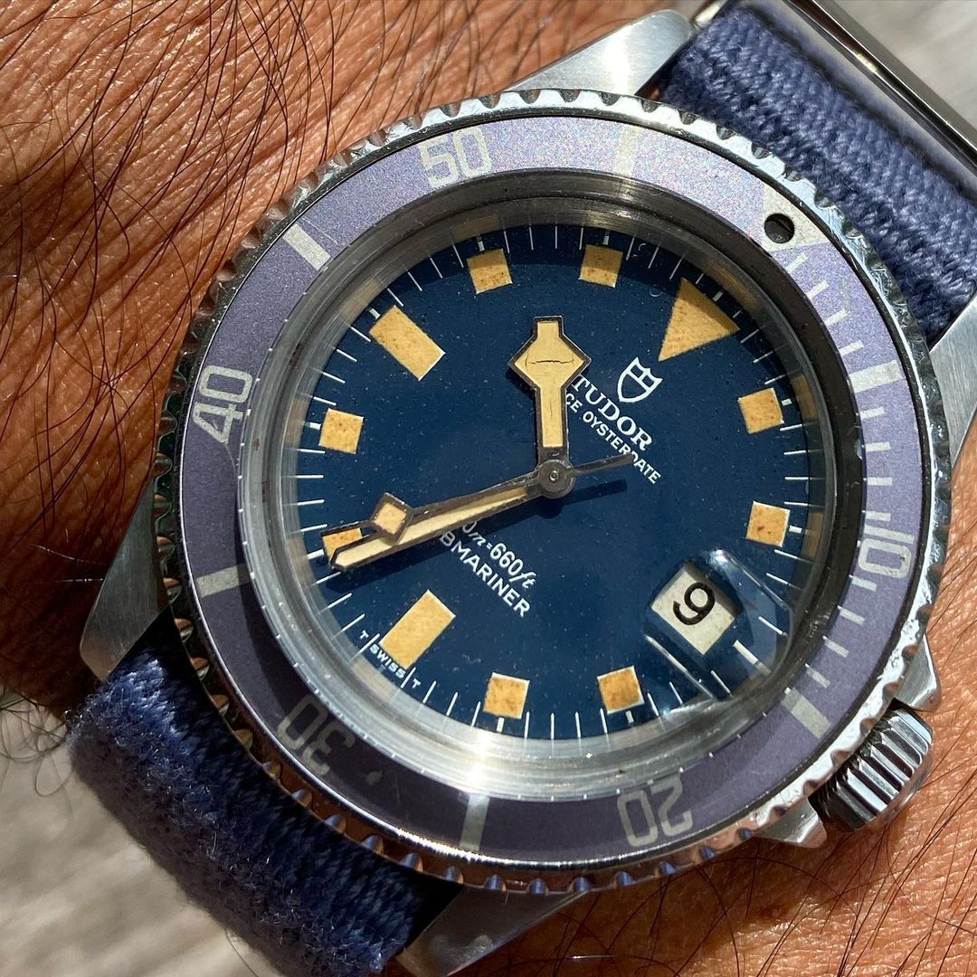 Tudor Oysterdate Submariner with a blue dial, yellow-tinted indices, and VTG Mil in Blue strap by RSM, featuring a single pass design.