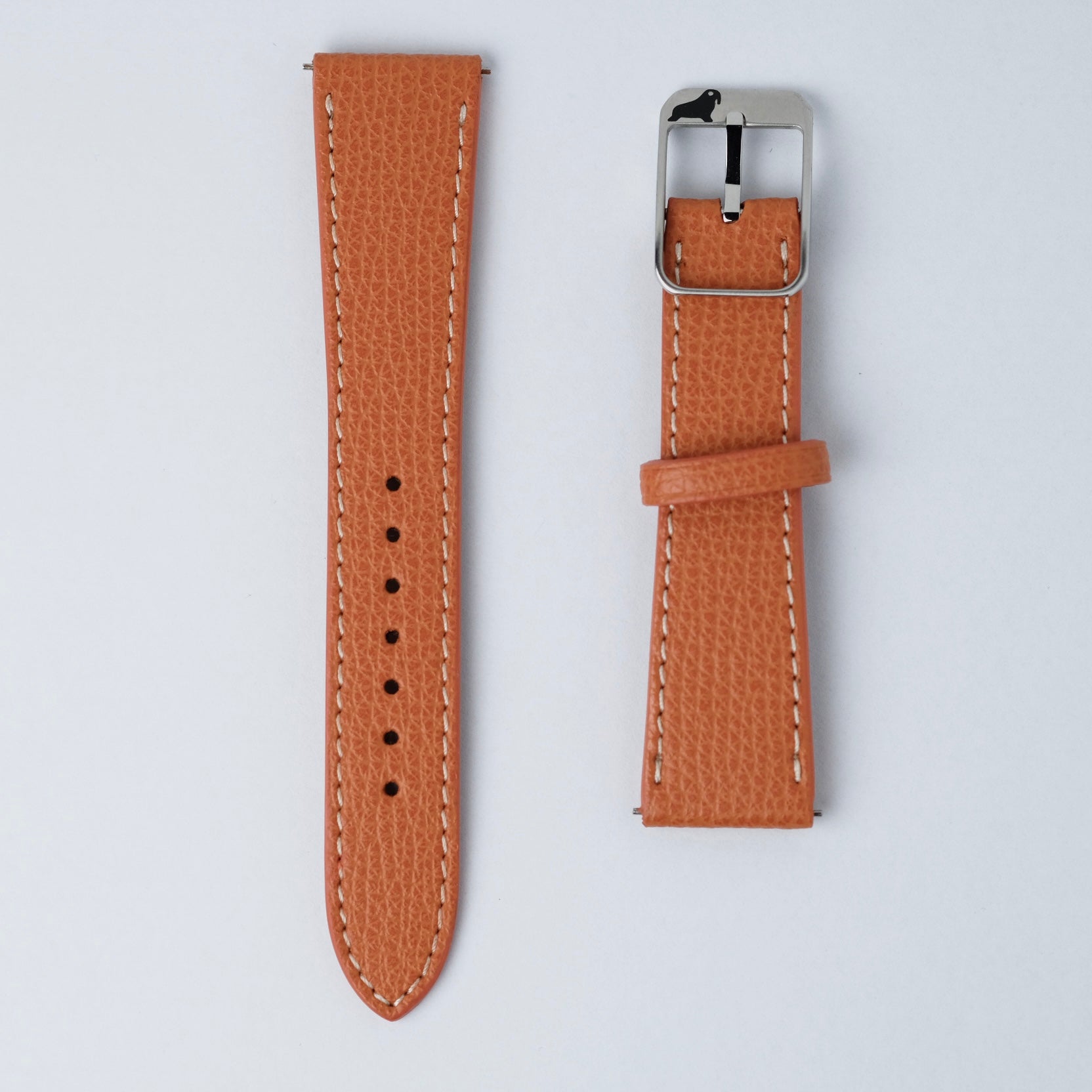 Two pieces of the RSM Watch Strap Italian Epsom Leather Watch Strap in Orange are laid flat on a white surface; one piece features holes and the other a silver buckle.