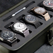 The RSM Watch Strap Watch Tool Box T-320 in green securely holds five wristwatches—each with unique bands and faces—in individual foam slots, with a tool stored neatly above them, making it an ideal EDC watch storage solution that keeps everything organized.