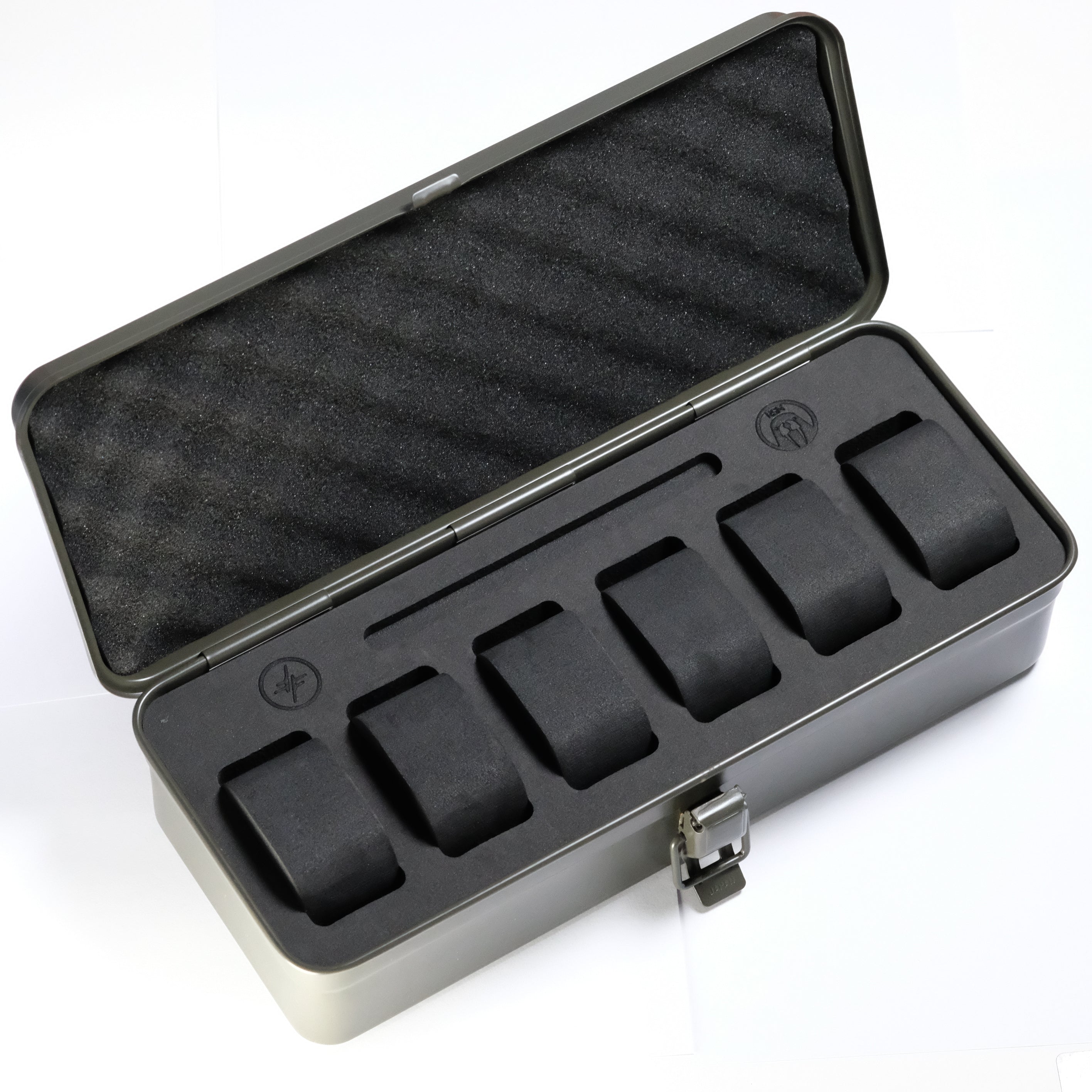 The Watch Tool Box T-320 by RSM Watch Strap features a durable metal case with a foam insert, offering six individual slots for organizing your items. Its open lid reveals black, padded compartments—making it perfect as an EDC watch storage solution or a practical Toyo Steel-inspired watch box for your collection.