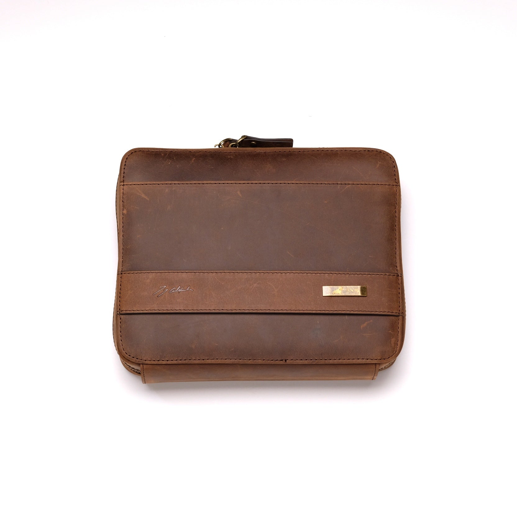 The 3-Piece Travel Watch Case in Brown Leather by RSM features a zipper closure and a metallic label, offering a simple, classic design with a worn texture.