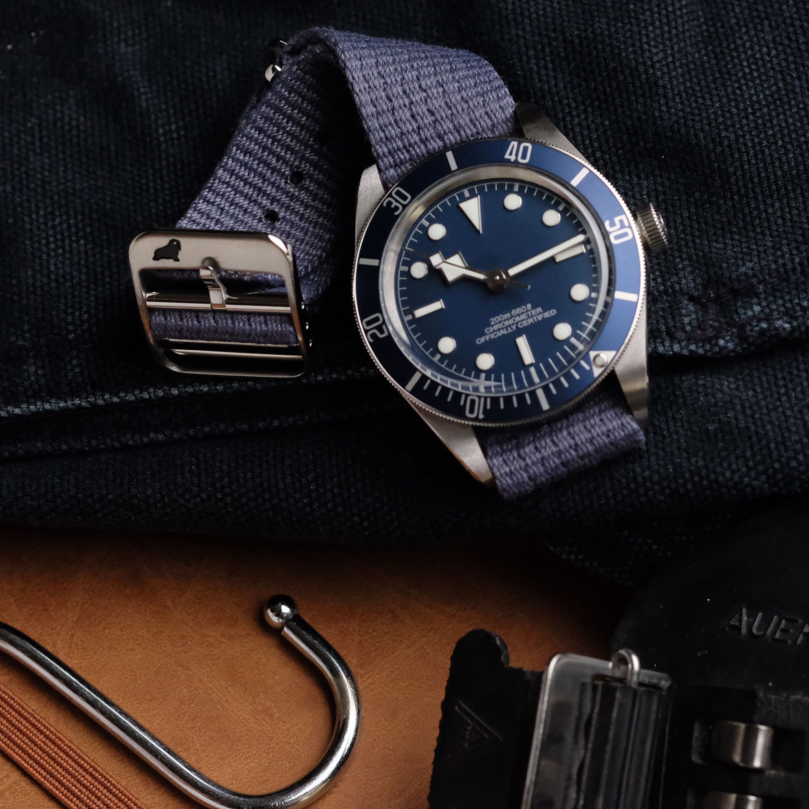 The RSM VTG Mil in Blue pairs a silver watch with a blue dial, bold white markers, a rotating bezel, and a stainless buckle.